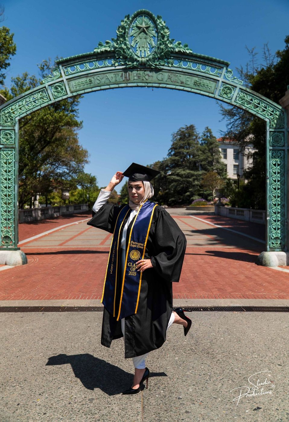Graduate jumping for joy beneath Sather Gate