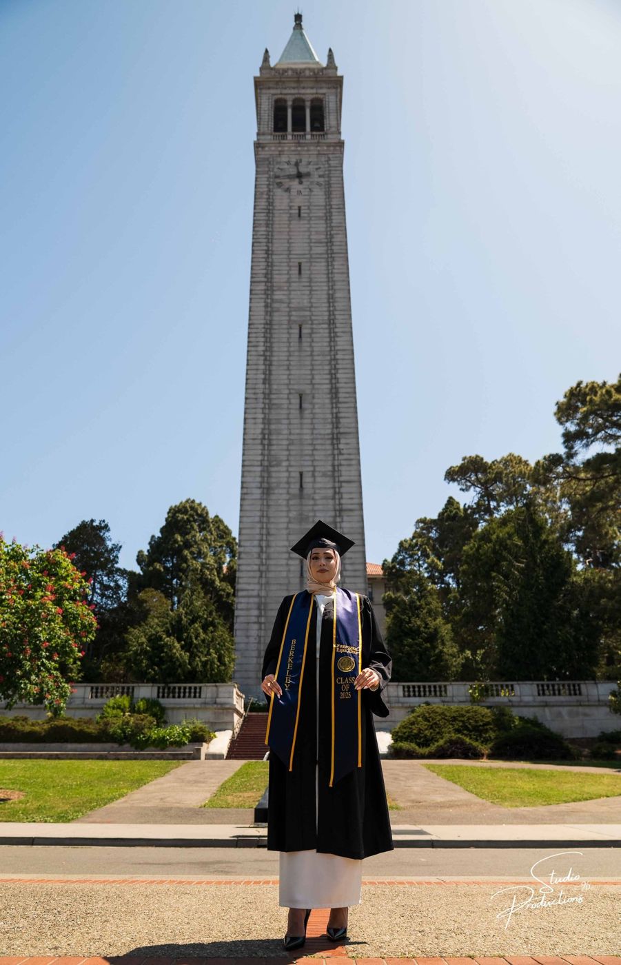 Full-length portrait of the graduate with the Campanile behind her