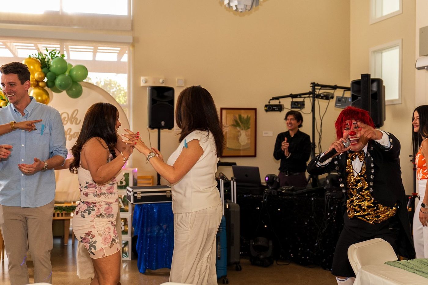 Guests gathered near the sound equipment and a costumed performer at the celebration