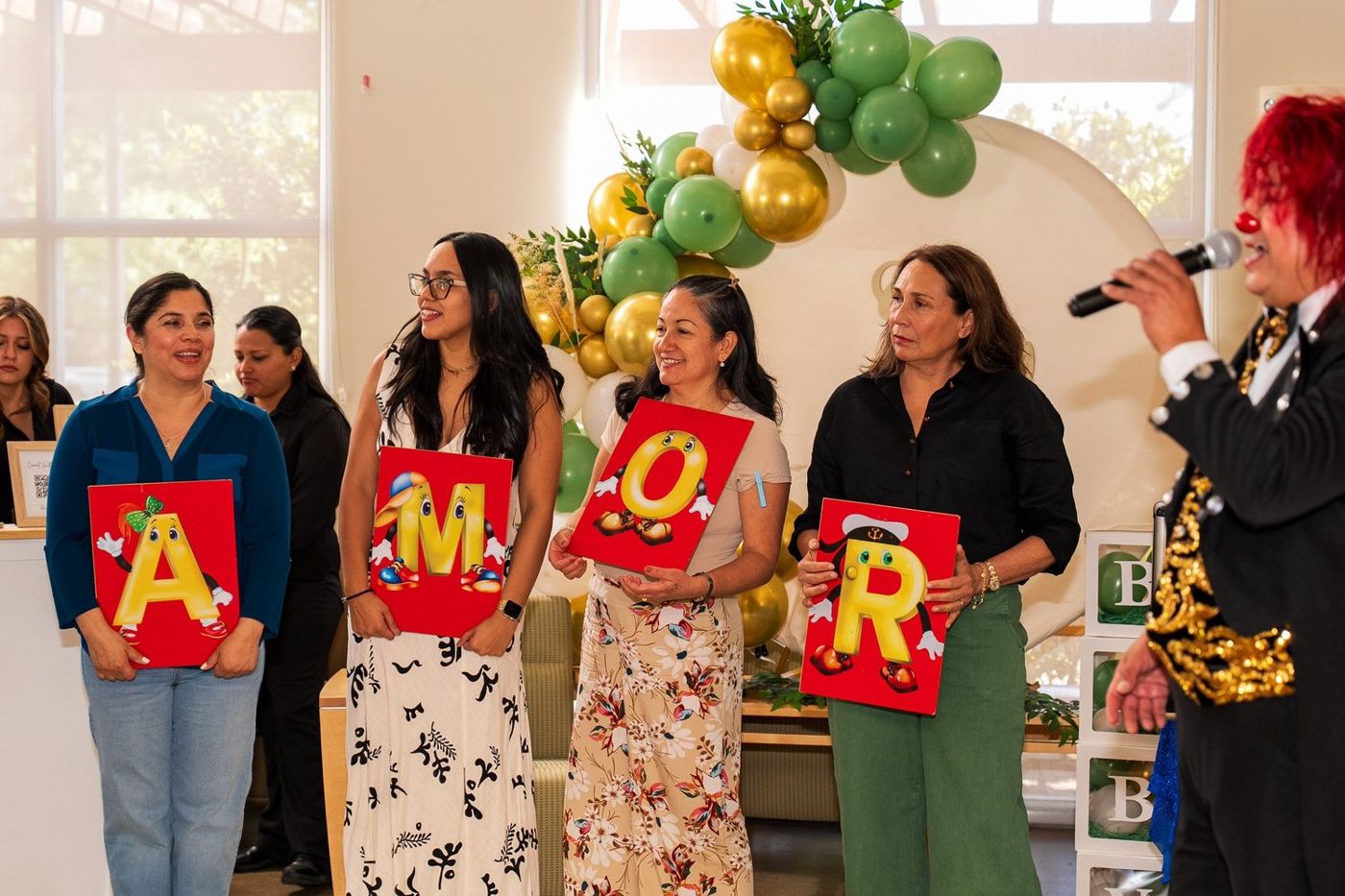 Group of guests holding oversized letters spelling out a message