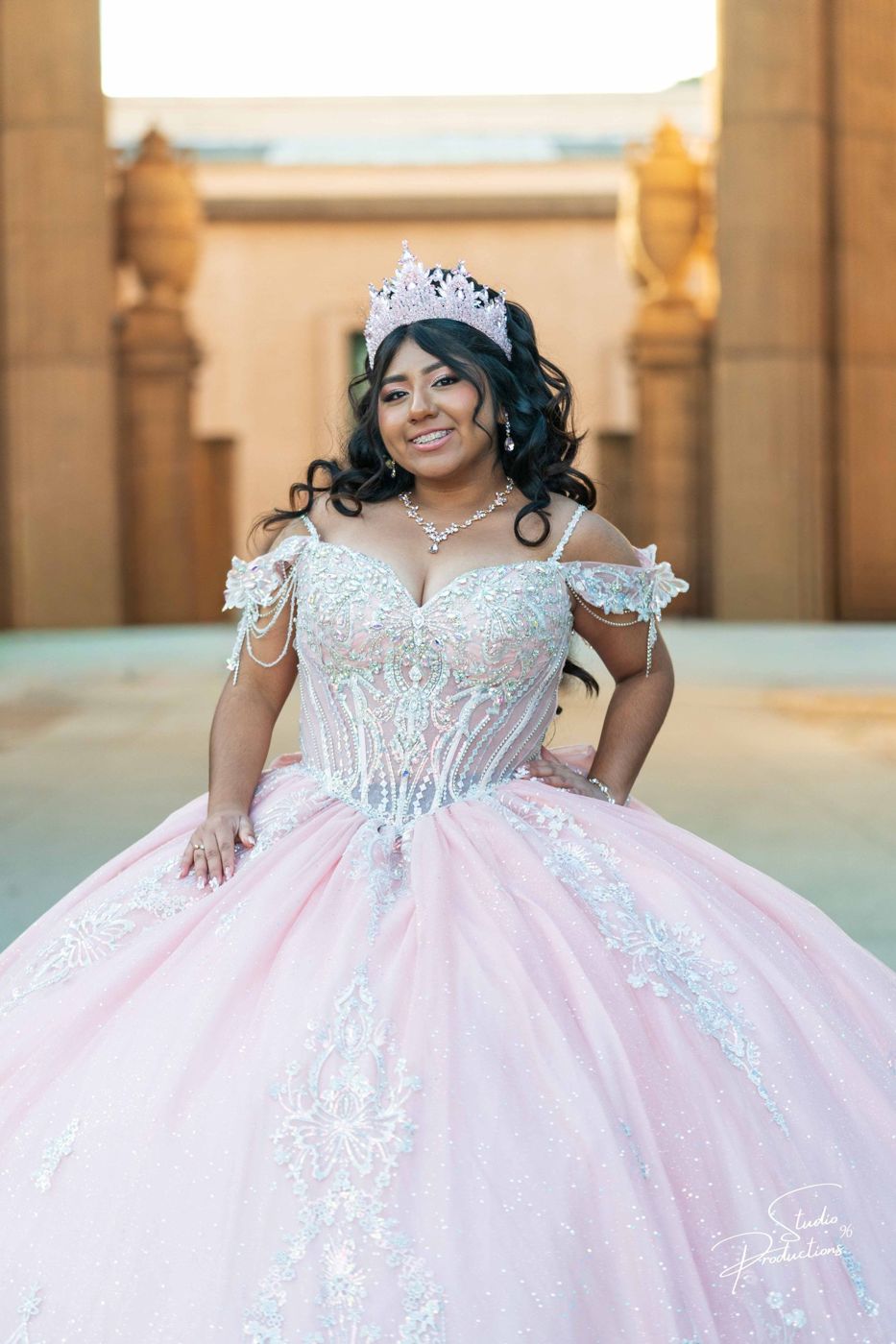 Portrait of the quinceañera in her tiara and pink gown