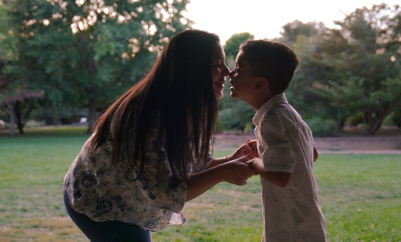 Mother and son touching foreheads in a tender moment