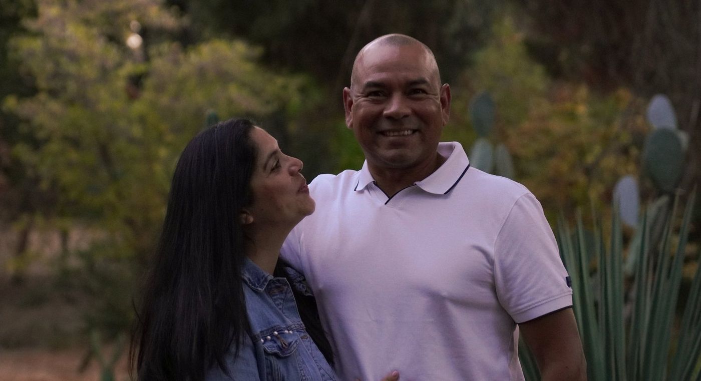 Father and mother close together, about to share a kiss