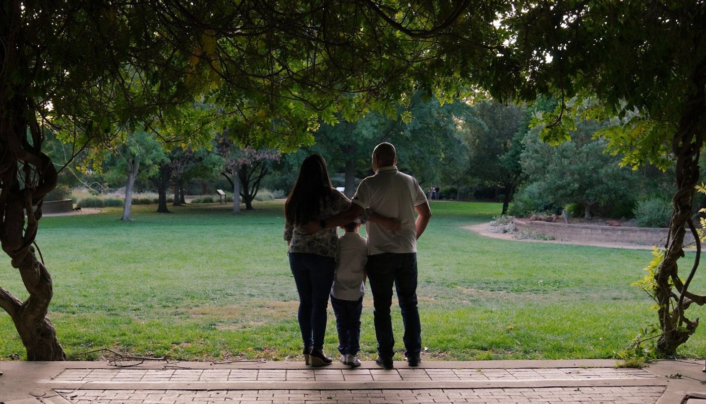Family walking away together down a garden path