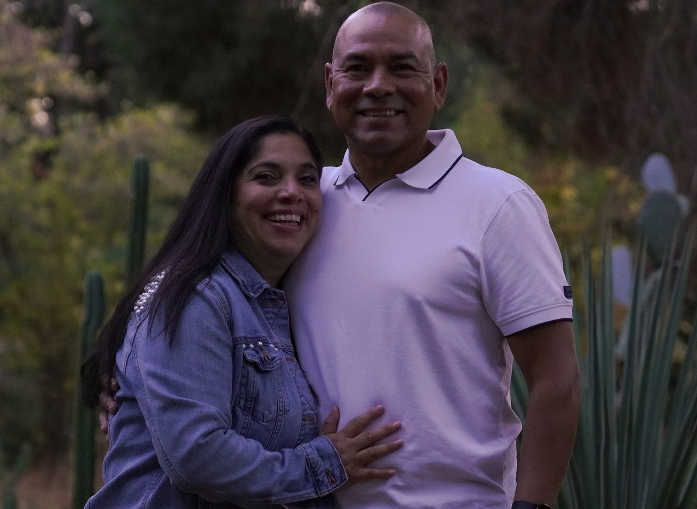 Parents embracing warmly in golden-hour light