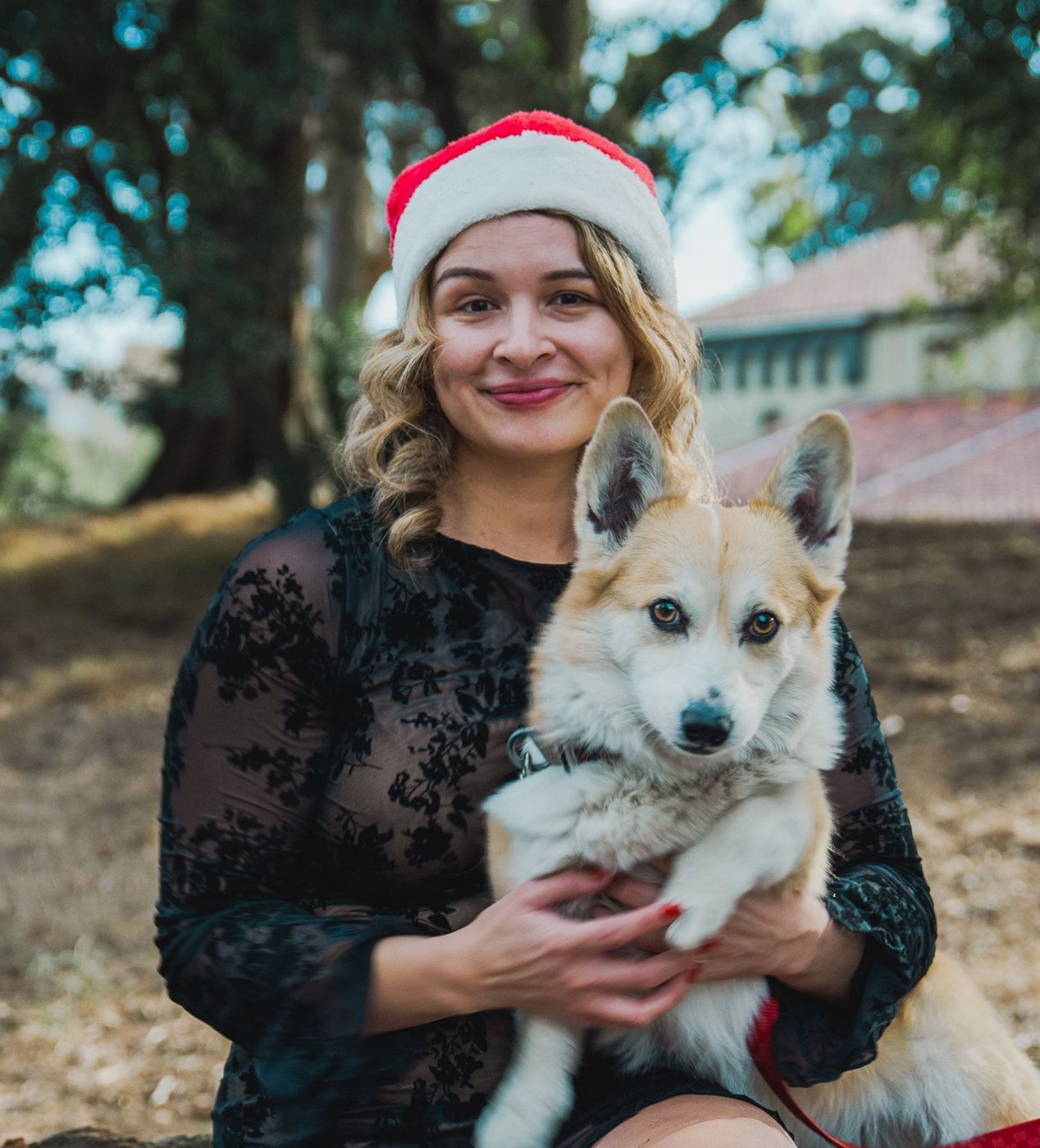 Close-up portrait of the woman holding one corgi