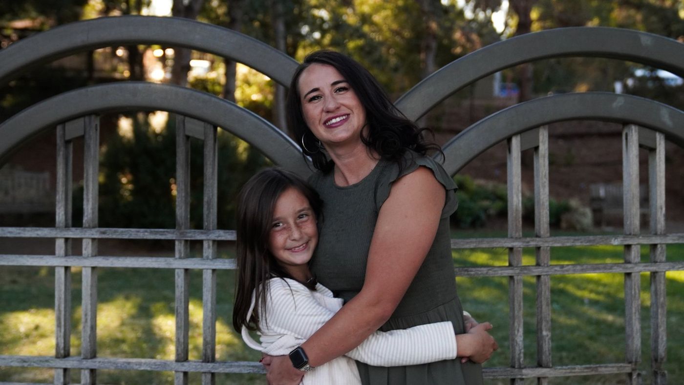 Mother and daughter cheek to cheek in a tender close-up