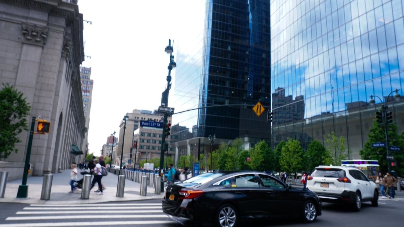 A busy Manhattan crosswalk lined with traffic