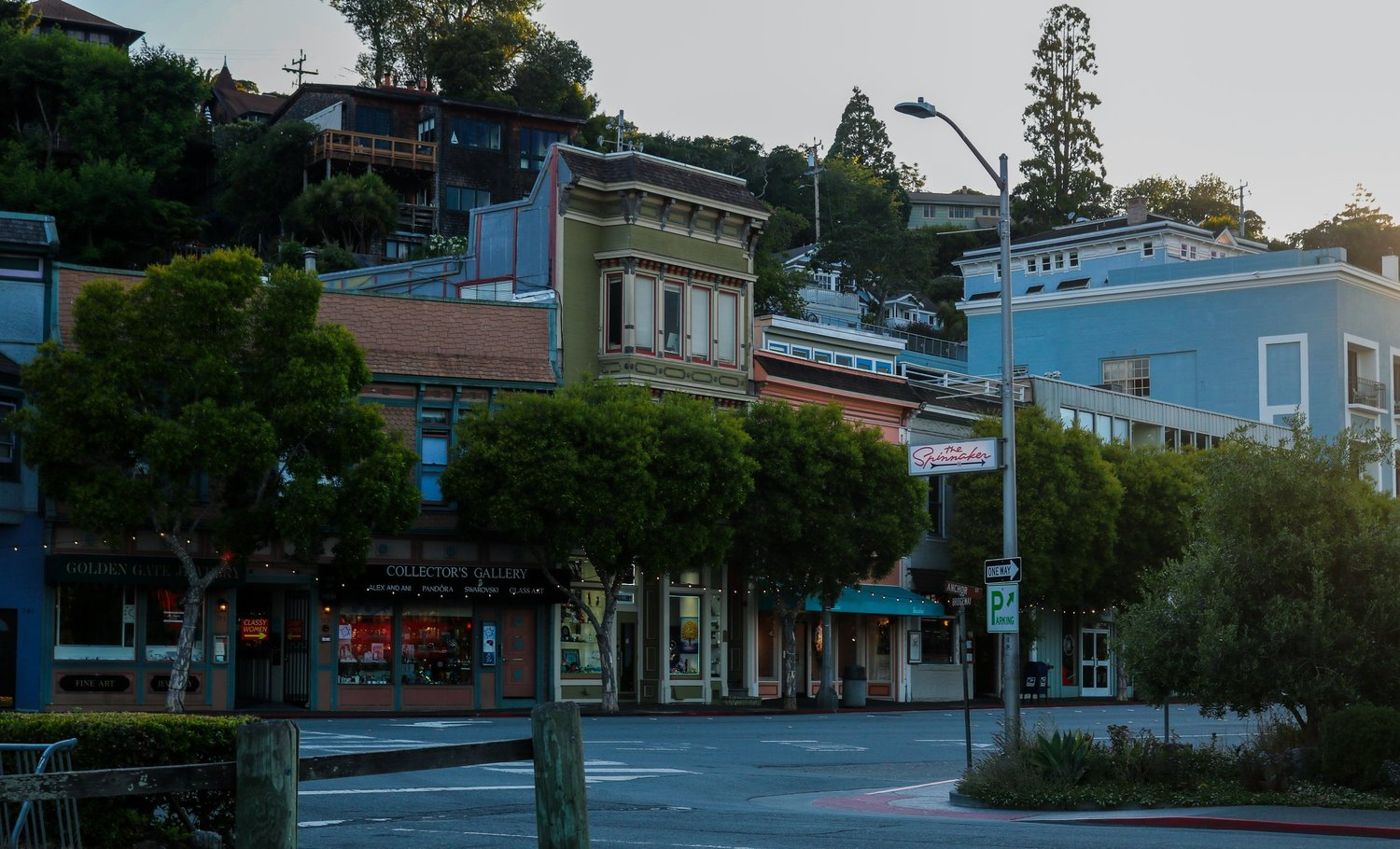 Colorful storefronts lining a Sausalito street