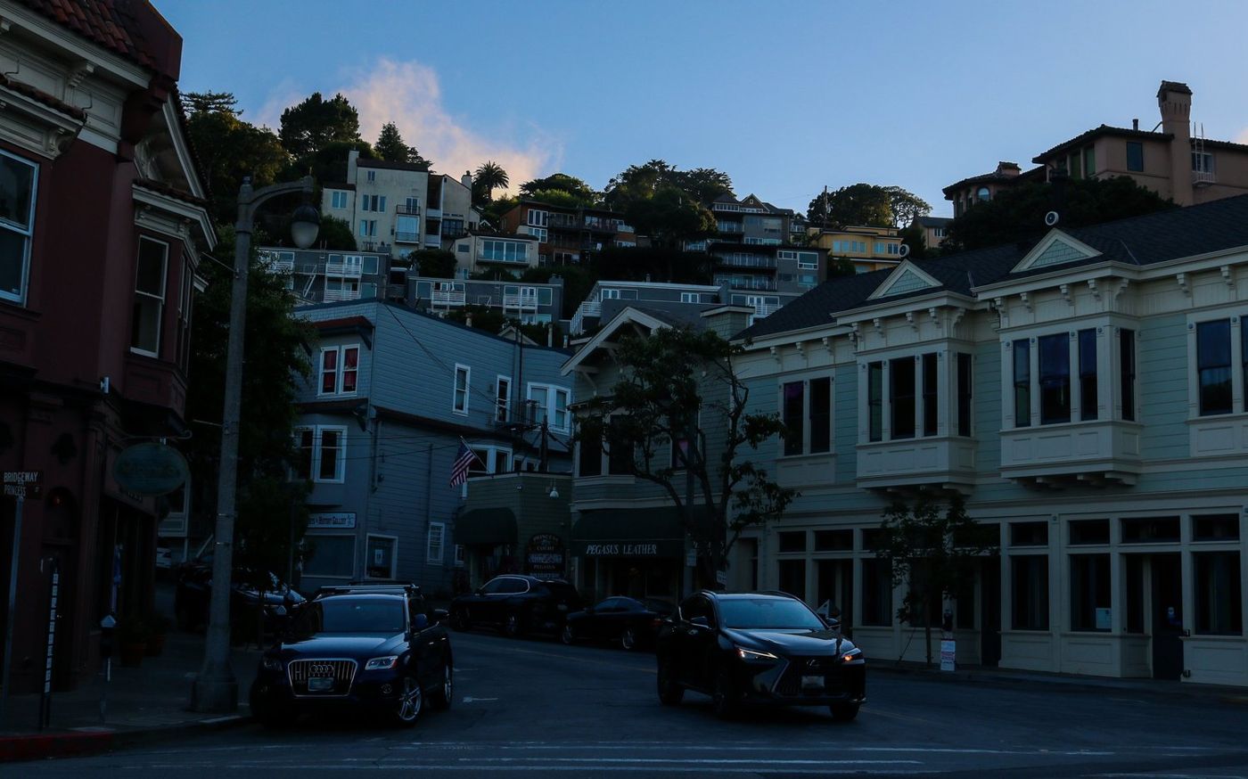 Hillside houses above a Sausalito street with parked cars