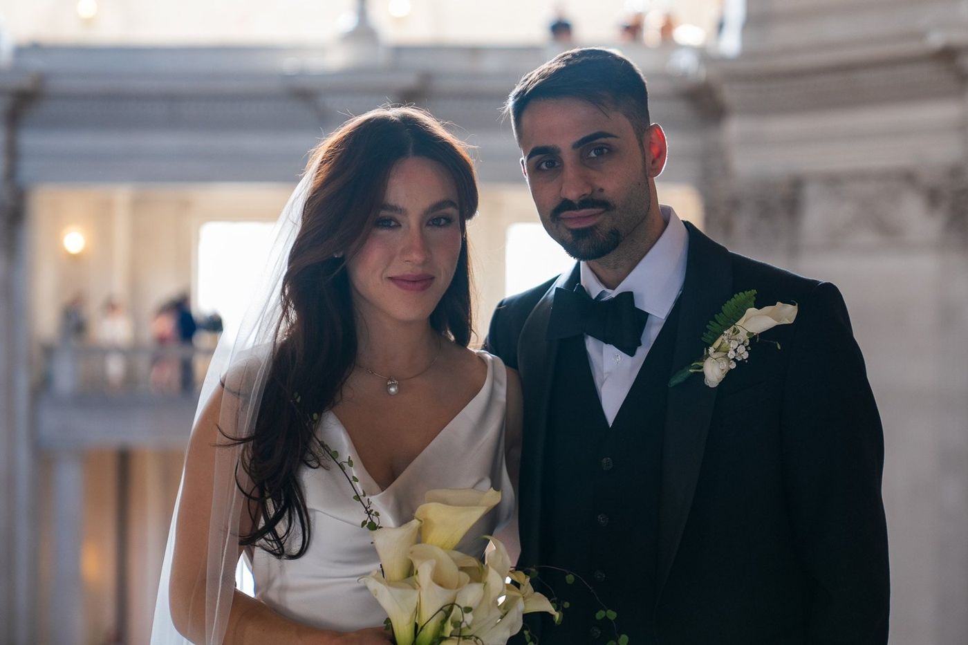 Bride and groom with calla lily bouquet at San Francisco City Hall