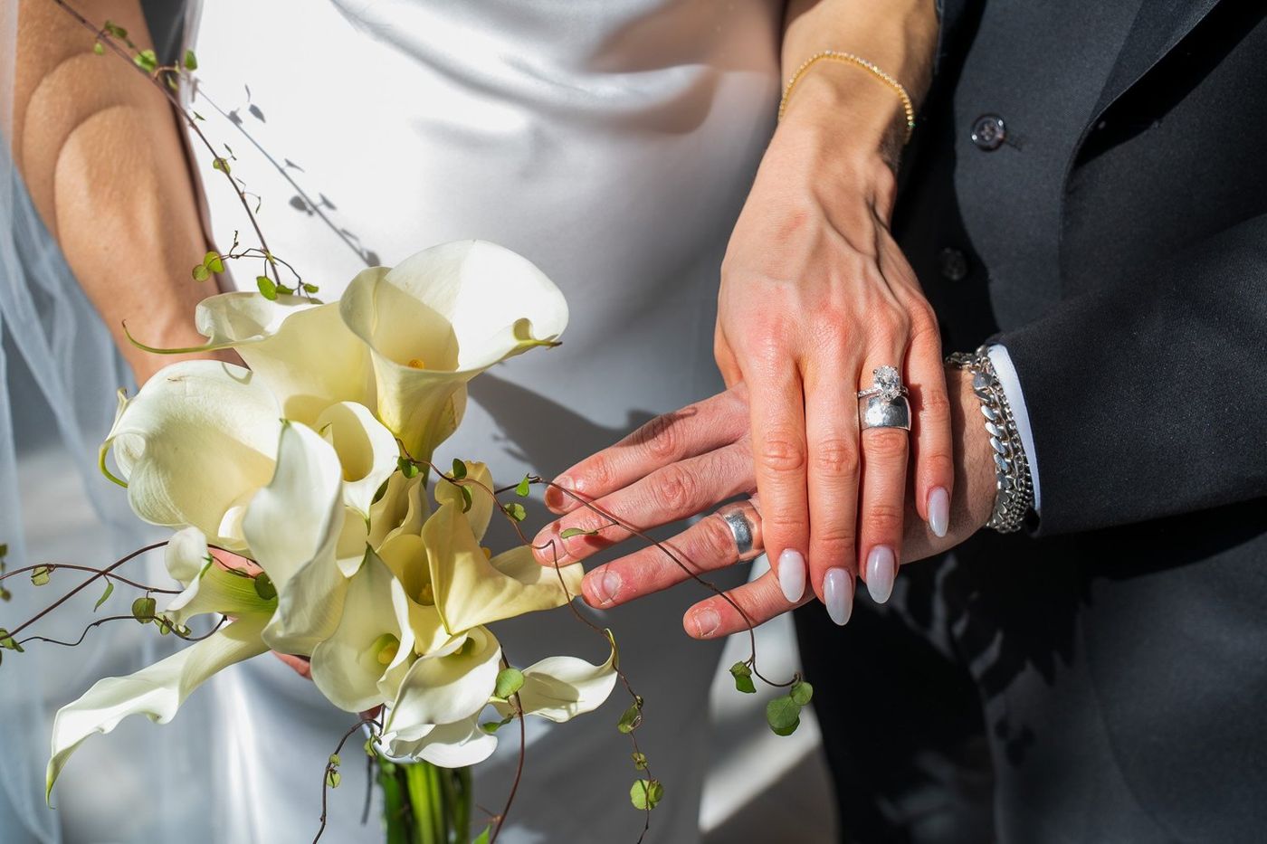 Close-up of the couple's hands and wedding rings after the ceremony
