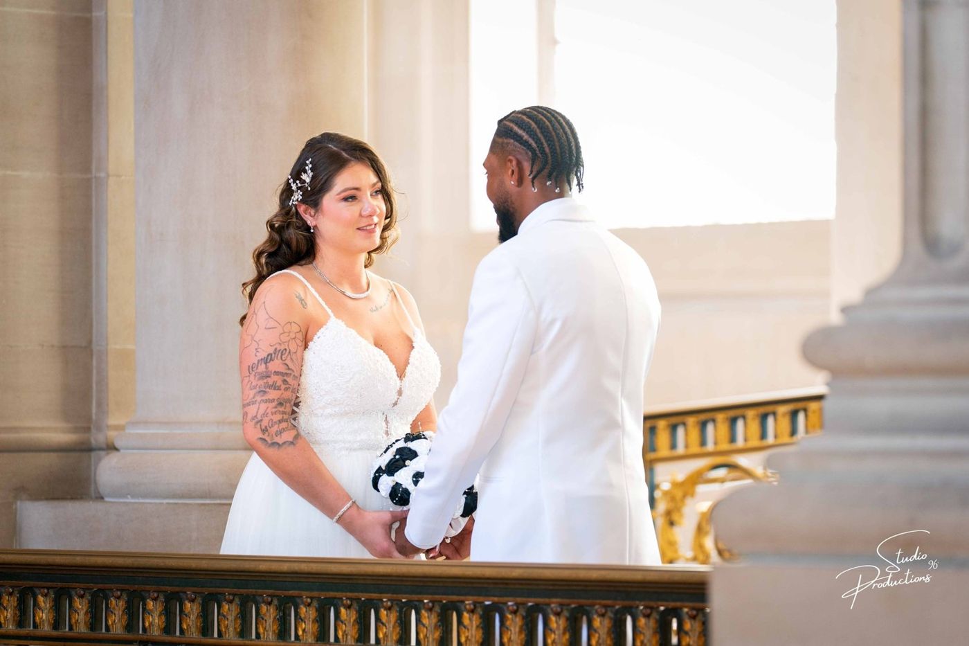 Couple holding hands at their San Francisco City Hall wedding ceremony