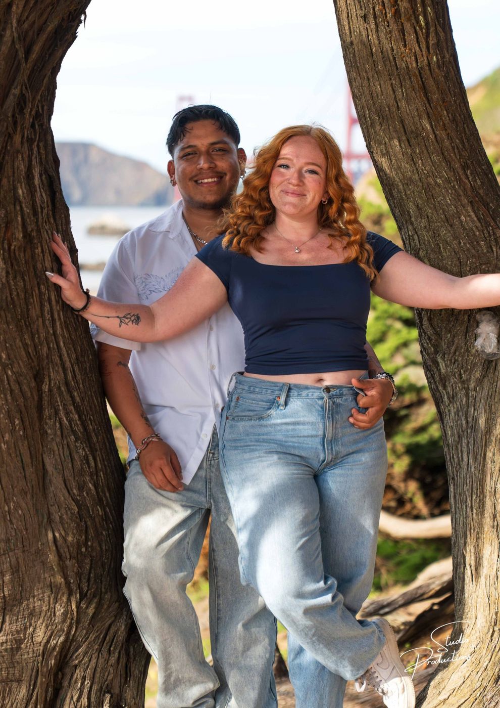 The couple embracing, framed within a gnarled tree trunk